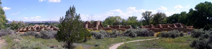 [Several photographs stitched together to display a large adobe brick structure with what appears to be at least two dozen rooms in one row.]